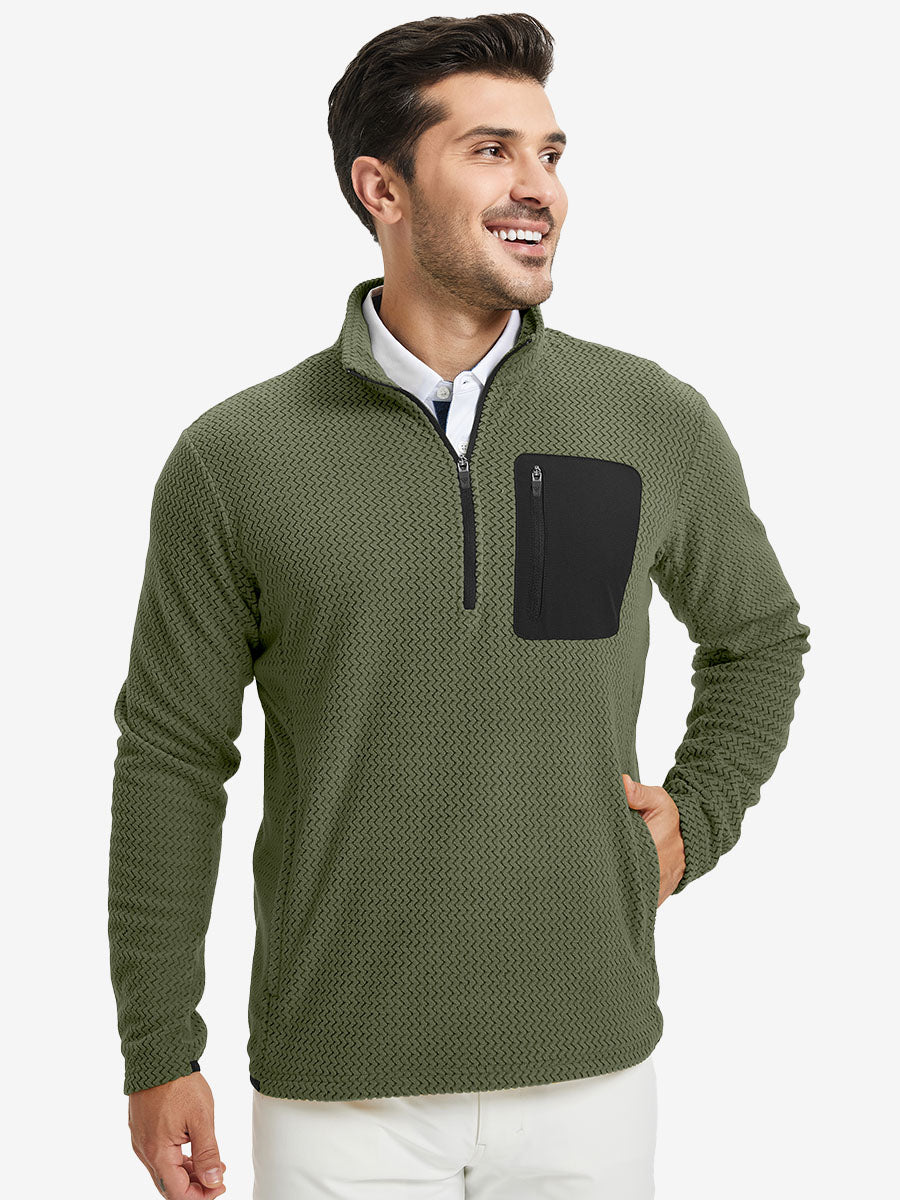 Model with one hand in side pocket, wearing midweight warm stretchy quarter zip pullover in green.