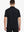 Back view half-body of model in BLACK Ventilated Pique Performance Polo