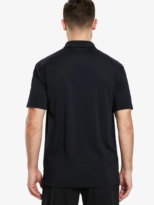 Back view half-body of model in BLACK Ventilated Pique Performance Polo