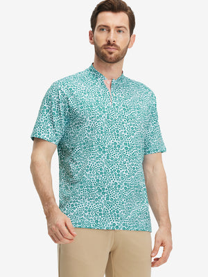 Front half-body of model in white green florals stretch printed collarless henley golf shirts