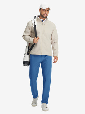 Model carrying a tennis bag, wearing colony blue lightweight flat front casual trousers in full-body view.