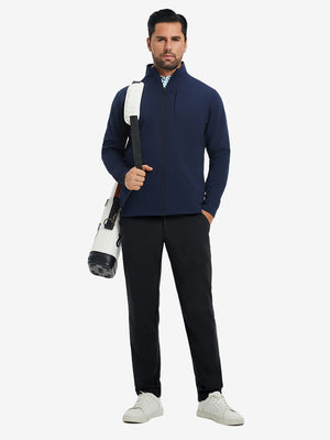 Model carrying a tennis bag, wearing water-resistant golf stretch nylon pants in black, full front view.