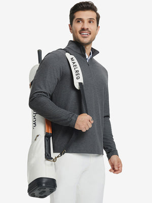 Model carrying golf bag in Premium jacquard quarter zip pullover with versatile dark grey