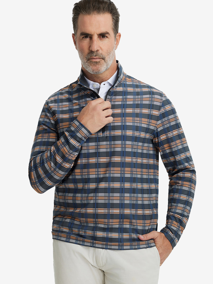 Front upper body view of model standing in blue/white/yellow plaid full print quarter zip pullover, relaxed look.