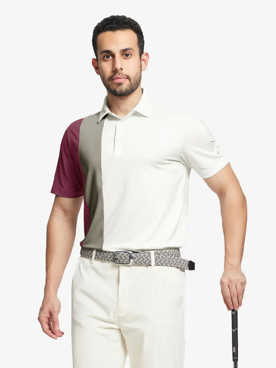Half-body front view of model holding golf club wearing CREAM Moisture Wicking Color Block Polo Shirt.