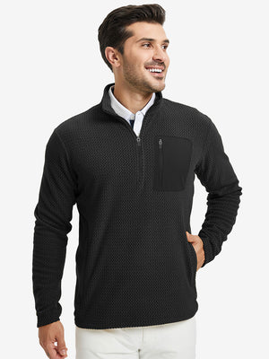 Model with one hand in side pocket, wearing midweight warm stretchy quarter zip pullover in black.