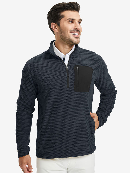 Model with one hand in side pocket, wearing midweight warm stretchy quarter zip pullover in navy.