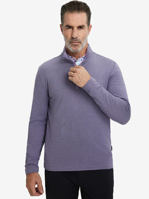 Model grabbing half-zip collar, wearing casual fleece lined quarter zip pullover in purple.