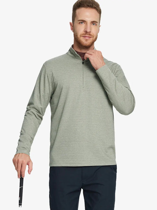 Half-body front view of model holding golf club wearing SAGE GREEN HOUNDSTOOTH Premium Jacquard Quarter Zip Pullover.								

