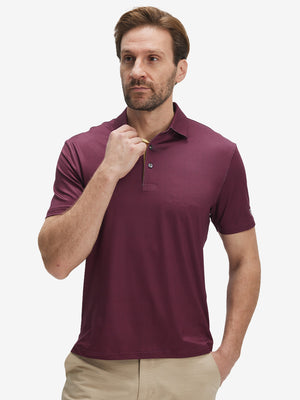 Front half-body shot of model wearing the burgundy geometric 4 way stretch print collared polo shirt for a casual sporty look