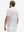 Back half-body view of model wearing the white polka dots 4 way stretch print collared polo shirt, highlighting the rear silhouette