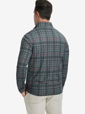 Back upper body angle of the retro black/red plaid full print quarter zip pullover, model turns head slightly.