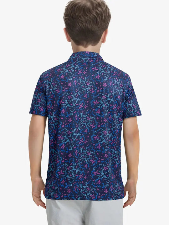 Back half-body view of boy wearing NAVY COLORFUL FLOWER Performance Print Boys Golf Polo outdoors
