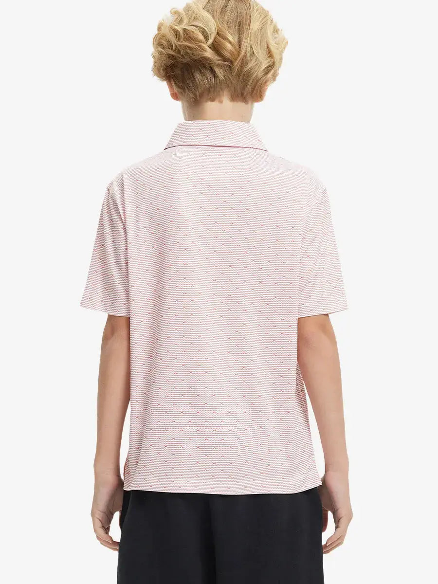 Back half-body view of boy wearing ORANGE SEA WAVE Performance Print Boys Golf Polo outdoors