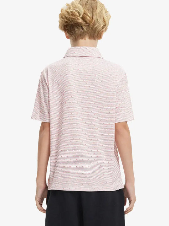 Back half-body view of boy wearing ORANGE SEA WAVE Performance Print Boys Golf Polo outdoors