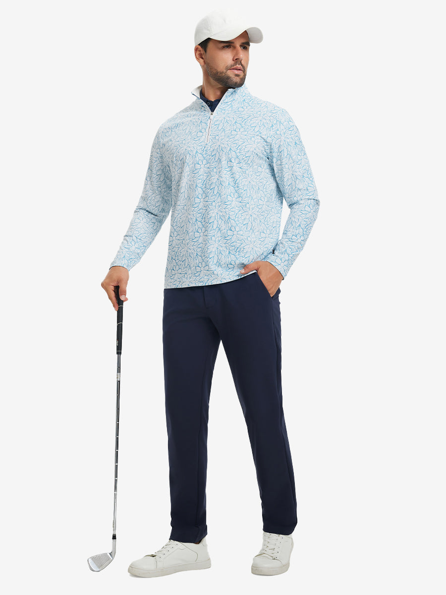 Full-body shot of model holding golf club, dressed in full print quarter zip pullover in blue artichoke.