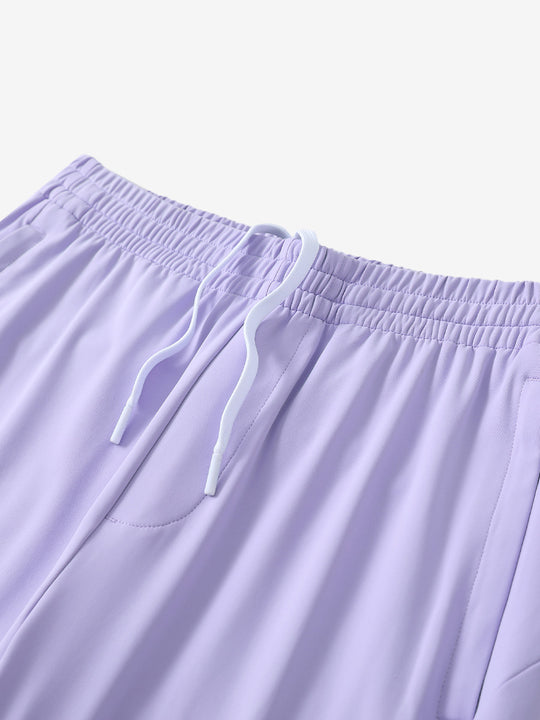 Angled view of lightweight women's stretchy joggers sweatpants waistband displayed in lavender purple.