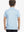 Back half-body view of boy wearing BLUE DINOSAUR Performance Print Boys Golf Polo outdoors