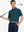 Model holding golf club in TURQUOISE Elegant Performance Jacquard Polo, front half-body view