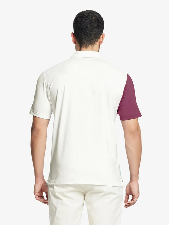Back half-body view of model in CREAM Moisture Wicking Color Block Polo Shirt.