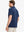 Back half-body view of model in DARK BLUE HEATHER Ventilated Heather Jacquard Polo