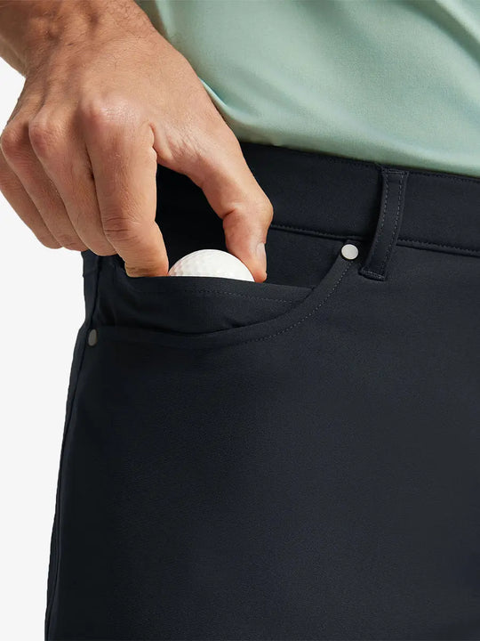 BLACK 4-way Stretch Performance Solid Shorts, front pocket holding golf ball detail, 9 Inch