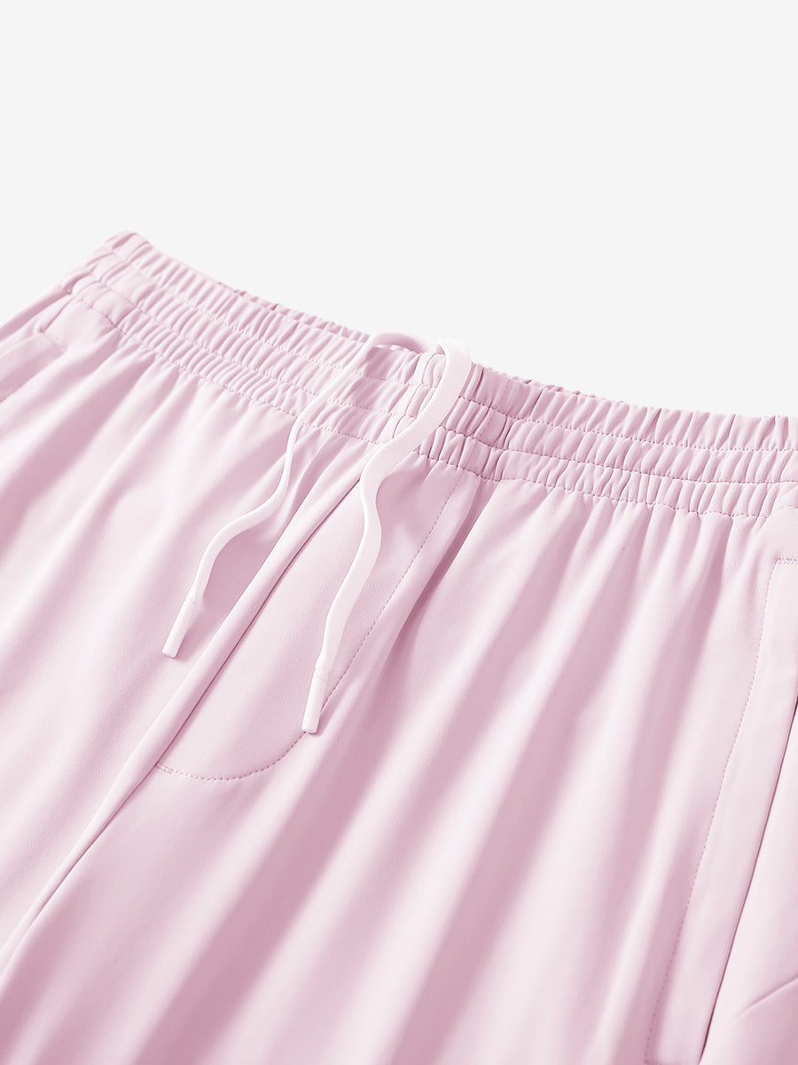 Angled view of lightweight women's stretchy joggers sweatpants waistband displayed in light purple.