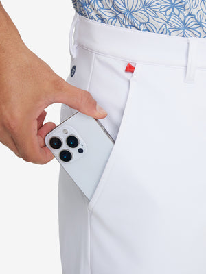 Side pocket detail of Golf Lightweight Fleece Lined Dress Pants in white, holding smartphone