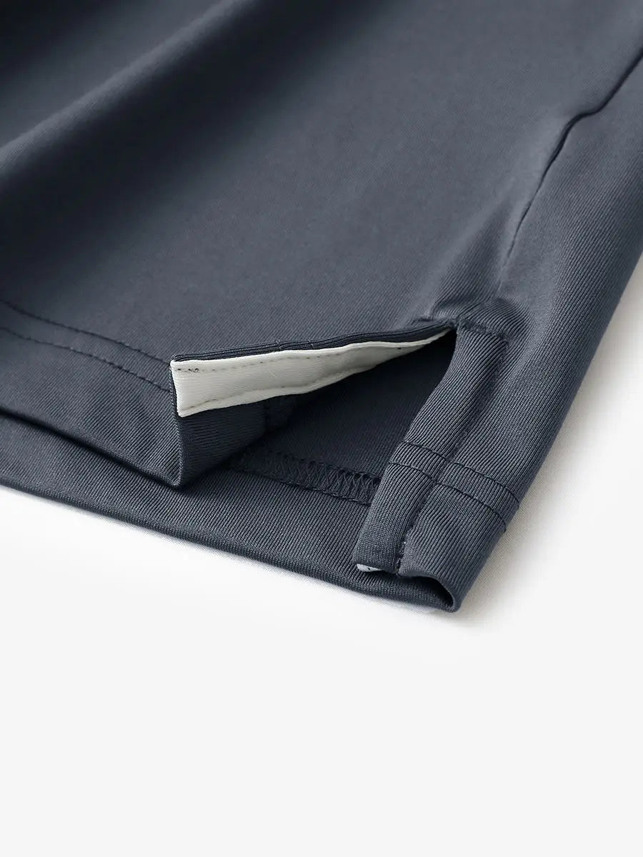Hem slit detail of DARK GREY Moisture Wicking Color Block Polo Shirt highlighting stitching and finish.