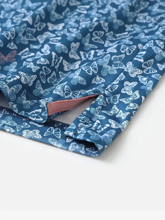 Close-up of hem slit on BLUE WHITE BUTTERFLY polo showing airflow and neat stitch