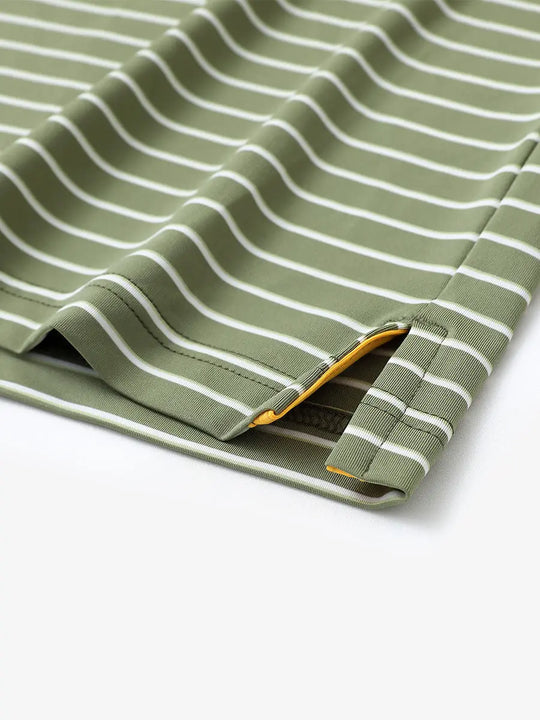 Hem slit detail of LIGHT GREEN/WHITE STRIPE Youth Performance Golf Polo highlighting stitching and finish.