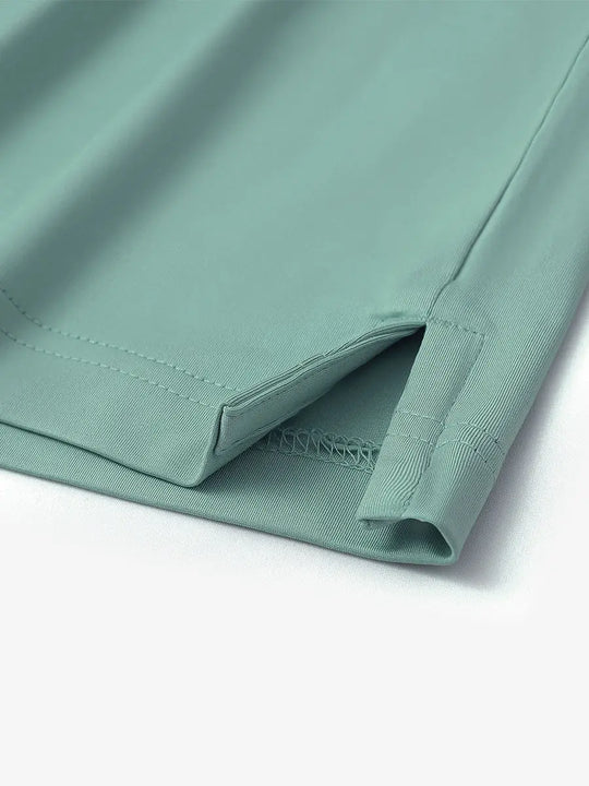 Close-up of hem slit detail on Everyday Solid Jersey Polo in BERYL GREEN, showing fine craftsmanship.