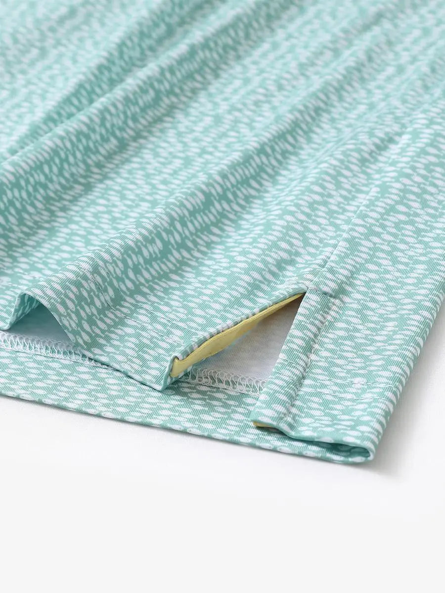 Hem slit detail of MAELREG Performance Jersey Print Polo in Green White Fish – comfort & movement