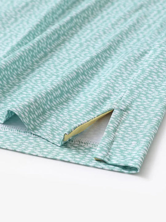 Hem slit detail of MAELREG Performance Jersey Print Polo in Green White Fish – comfort & movement