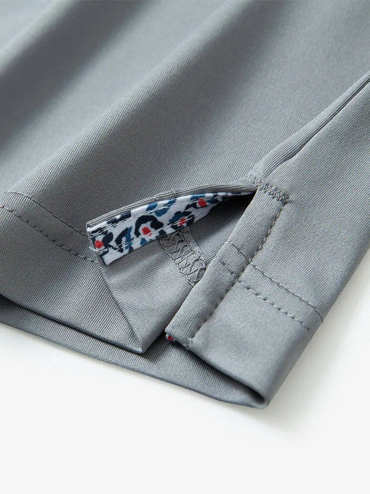 Close-up of side slit hem detail on LIGHT GREY Long Sleeve Solid Jersey Polo