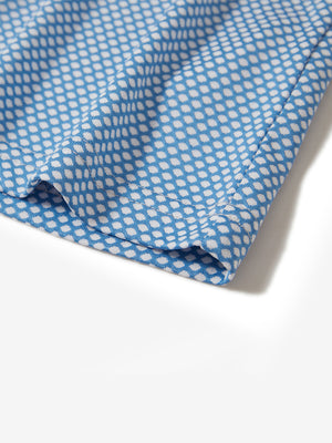 Hem detail of jacquard quarter zip pullover in blue/white, focusing on stitching and side vent finish.