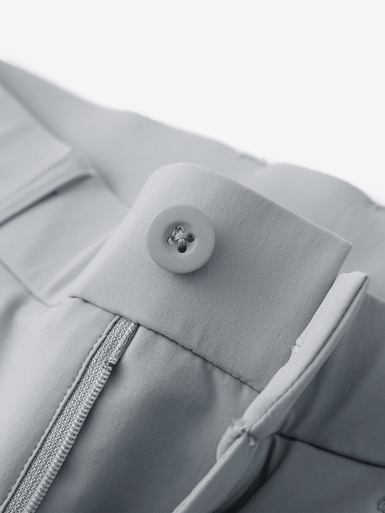 Waist detail of quick dry casual dress pants in light grey, featuring button and zipper design.