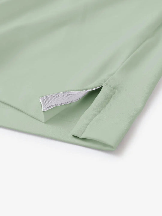 Hem slit detail of CANARY GREEN Moisture Wicking Color Block Polo Shirt highlighting stitching and finish.