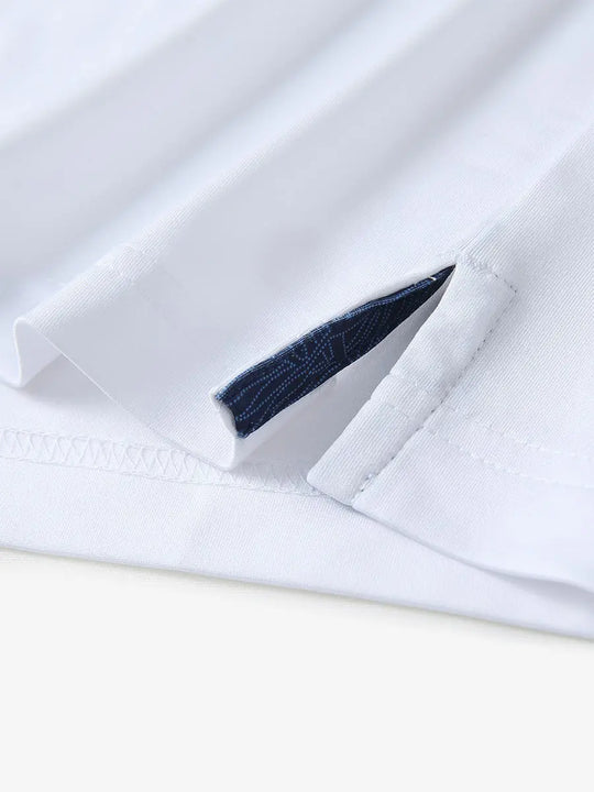 Close-up of side slit hem detail on WHITE Long Sleeve Solid Jersey Polo