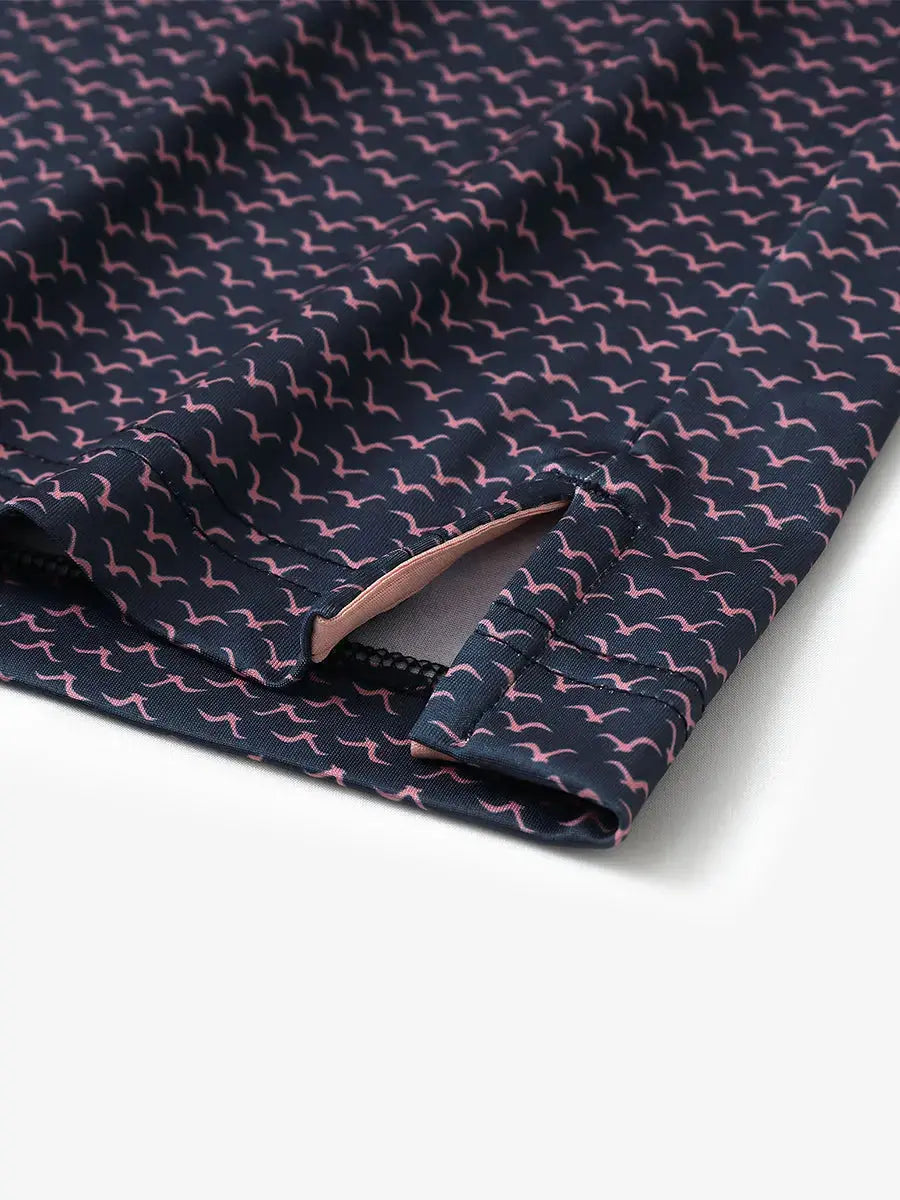 Detailed close-up of side hem slit on NAVY PINK SEAGULL Performance Print Boys Golf Polo for comfort