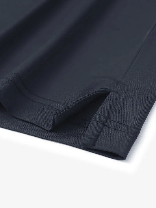 Close-up of hem slit detail on Everyday Solid Jersey Polo in DARK GREY, featuring quality stitching.