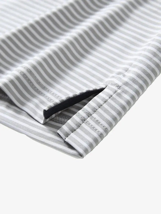 GREY WHITE STRIPEClose-up detail of side hem slit on Cooling Stripe Golf Shirt in GREY WHITE STRIPE, emphasizing comfort and finish