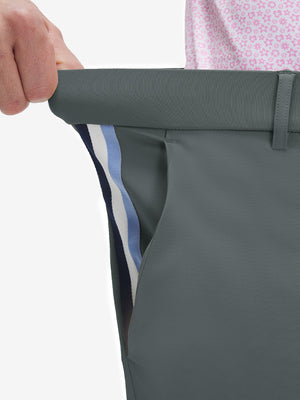 Detail view of elastic waistband on dark gray breathable casual slacks with 4 pockets
