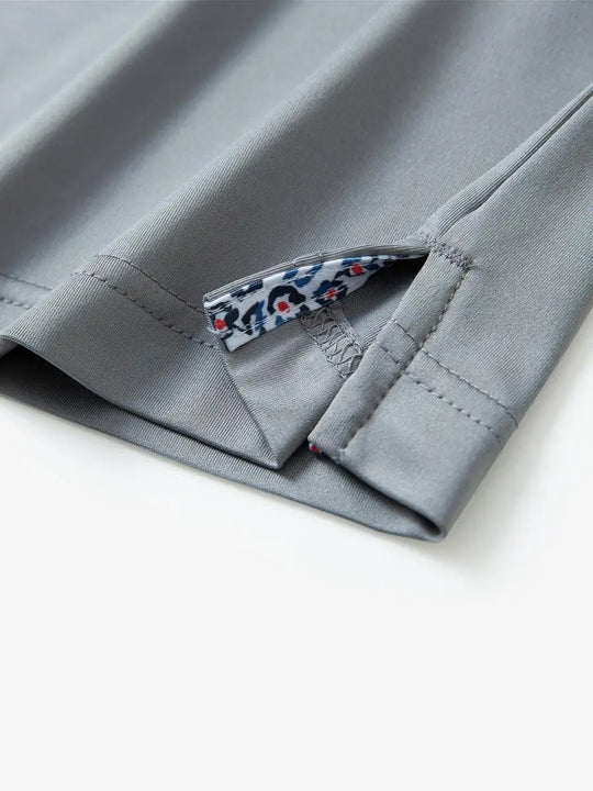 Close-up of side slit detail on the Light Grey Everyday Classic Solid Polo hem
