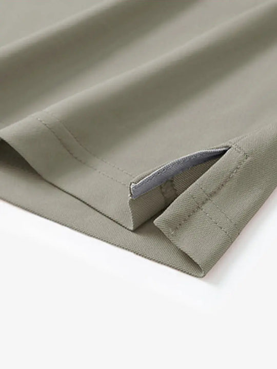 Detail view of the dark khaki long sleeve pique polo, focusing on the hem opening and stylish design.