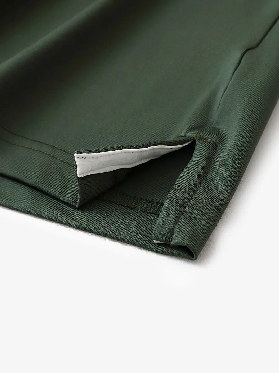 Hem slit detail of OLIVE GREEN Moisture Wicking Color Block Polo Shirt highlighting stitching and finish.