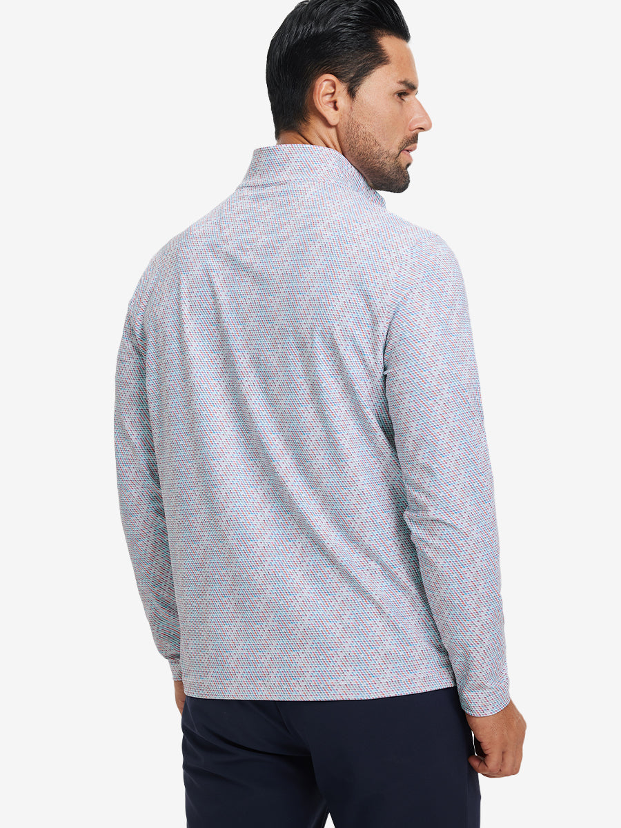 Back upper body angle of the colorful hexagon full print quarter zip pullover, model turns head slightly.