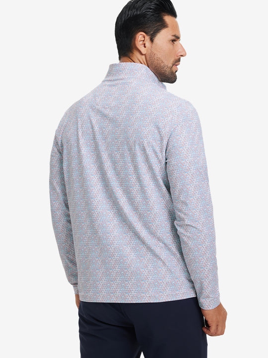 Back upper body angle of the colorful hexagon full print quarter zip pullover, model turns head slightly.