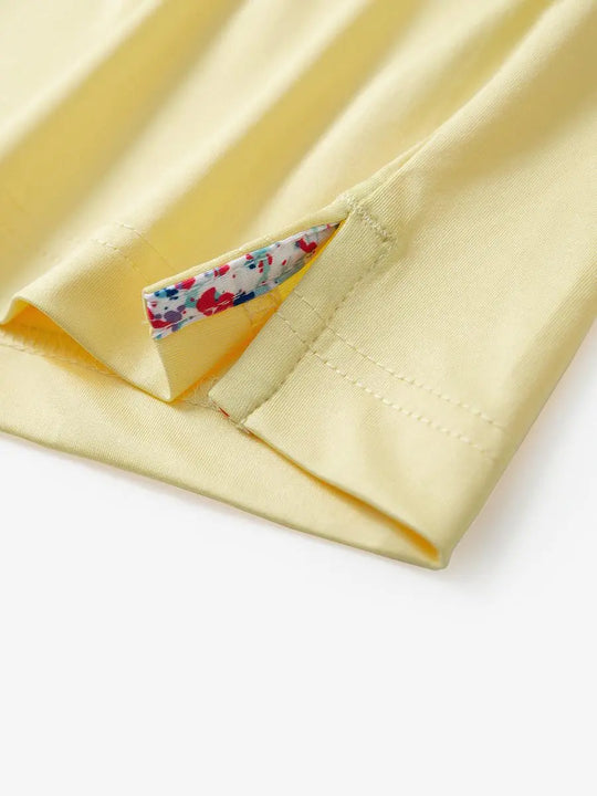 Close-up of side slit detail on the Yellow Everyday Classic Solid Polo hem