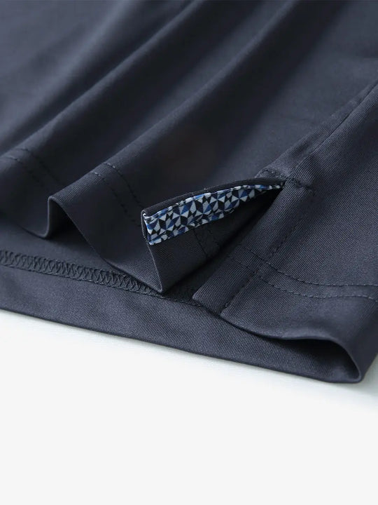 Close-up of side slit hem detail on DARK GREY Long Sleeve Solid Jersey Polo
